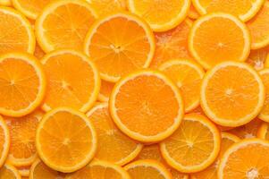 oranges cut into slices and laid out on the table as a food background 3 photo