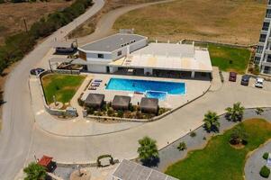 A top down shot directly above an pool, surrounded by green grass and trees photo