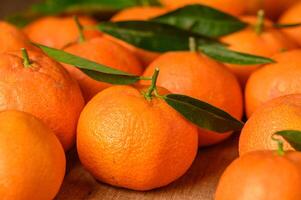 fresh juicy tangerines on a wooden table 2 photo