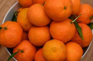 juicy tangerines in a plate on the table 3 photo