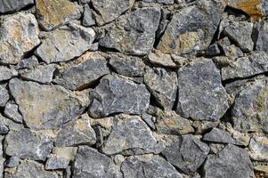 Old weathered stone wall of medieval fortress brick horizontal grunge background photo