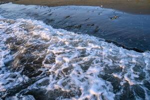 wavy lines water surface with bright glowing reflection abstract background photo