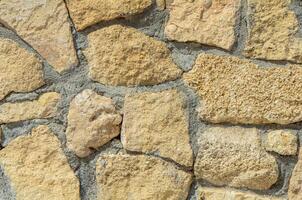 pattern decorative uneven cracked real stone wall surface with cement. with copy space image. Place for adding text or design photo