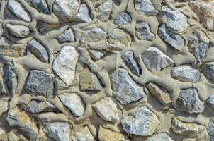 Full frame of a facade of a wall of stone constructed with volcanic rocks of origin photo