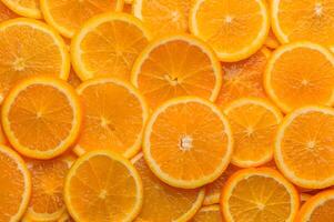 oranges cut into slices and laid out on the table as a food background 4 photo