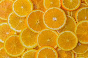 oranges cut into slices and laid out on the table as a food background 9 photo