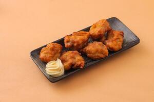 Japanese Fried Chicken with mayo dip served in dish isolated on background side view of japanese food photo