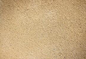 Beige plastered wall texture background photo