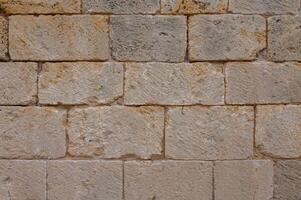 Texture of an ancient brick wall made of sandstone. Archaeological excavations 1 photo