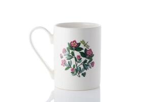 cup with a flower painted on it on a white background. Isolate 2 photo