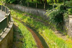 small stream of water runs down a hillside photo