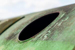 green metal object with a hole in the middle photo