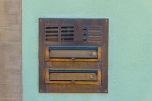 old mailbox with two compartments on a wall photo