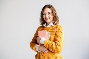 Cheerful Student with Digital Tablet. Smiling young woman holding a digital tablet, Ideal for themes of online learning, education technology, university admissions, and digital coursework. photo