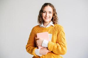 Smiling Woman Holding Digital Tablet. Happy young woman holding a digital tablet, standing against a white background. Perfect for online education, e-learning courses, digital technology photo