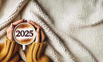 Happy New Year goal. Number 2025 on the frothy surface of cappuccino coffee in the cup photo
