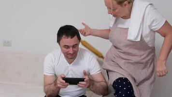 Interesting game on mobile woman with a rocking chair threatens her husband to beat her husband an abuser wants to play a game notice interest Sit down to play too drop everything video