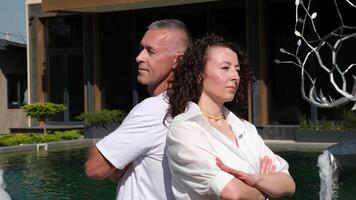 Resentful asian guy and girl acting like arguing couple and not speaking to each other while standing with each other's backs, Stressed, angry, not looking at each other, not asking for reconciliation video