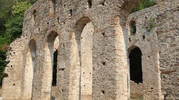 Restored old castle in Butrint in Albania. Aerial view of ruins of fortress in forest. Butrint Archaeological Park. Drone . video