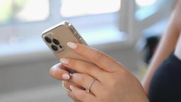 Female hands holding phone. Woman's finger guiding sensitive touchscreen. Editing videos in app. Using technology device for creating content for new post for social media. montage.