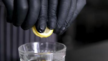 Add lemon to baking soda in a glass, healthy liquid. Woman adding baking soda into glass with water video