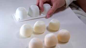 Photos of motti of different colors with different fillings isolated on background, a delicious colored dessert. video