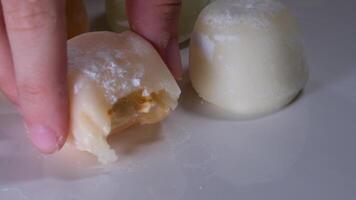Photos of motti of different colors with different fillings isolated on background, a delicious colored dessert. video