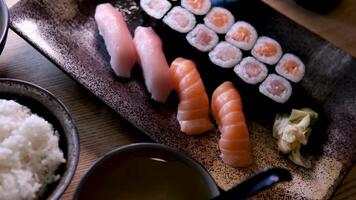 Sushi set Japanese food with rice, red raw fish, cream cheese, salmon, shrimp, avocado and nori. Appetizing sushi set with rolls on the table. Incredibly tasty and expensive food from a sushi chef video
