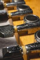 Close up from a Headstock of a guitar made of Maple wood, and some silver color tuners. photo