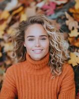 Woman With Curly Hair Relaxing Among Colorful Autumn Leaves in a Park photo