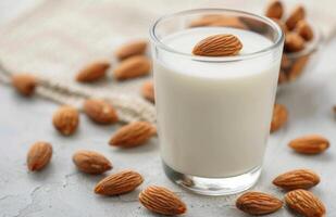 Almond Milk With Almonds on a White Background in a Natural Setting photo