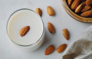 Almond Milk With Almonds on a White Background in a Natural Setting photo
