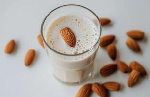 Almond Milk With Almonds on a White Background in a Natural Setting photo
