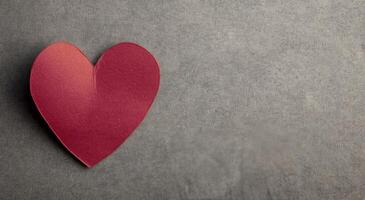 Red Heart Paper Cutout on Textured Gray Background photo