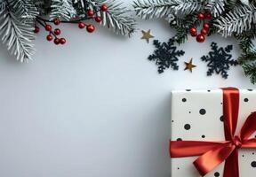 Wrapped Christmas Gift Surrounded by Stars and Evergreen Foliage on White Background photo