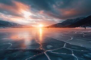 Sunset Over Frozen Lake With Cracked Ice And Majestic Mountains photo
