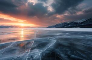 Sunset Over Frozen Lake With Cracked Ice And Majestic Mountains photo