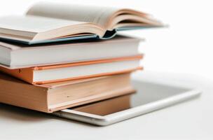 Stacked Books on a Tablet With Open Pages in a Minimalist Workspace photo
