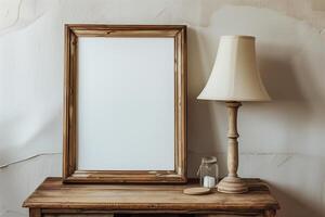 a wooden table with a blank white canvas with wood frame and a lamp photo