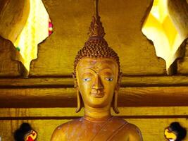 Buddha statues and sculptures at Phra That Luang or Phra Chedi Lokachulamanee is considered a very important place of worship in Vientiane, Laos. photo