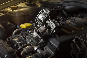 A finger indicates a faulty engine piston photo