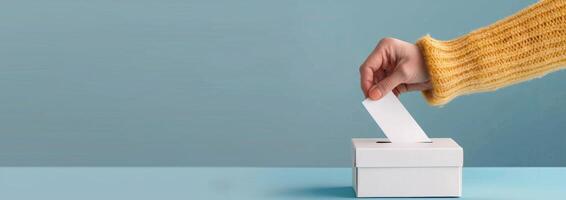 Hand Casting Vote Into Ballot Box During Election Day photo