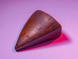 Close-up of a wooden object with a triangular shape. photo