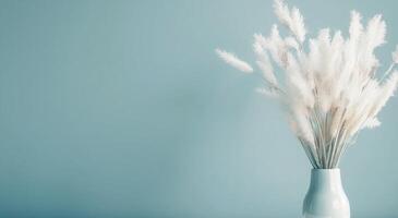 Elegant White Dried Flowers in a Pale Vase Against a Teal Background photo