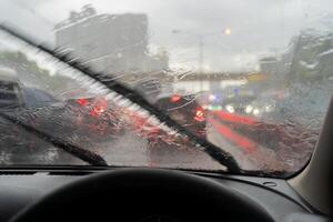 Heavy rain, visibility is difficult. Turn on the wiper to help solve the problem. So that you can see the front. The problem is very traffic jam. photo