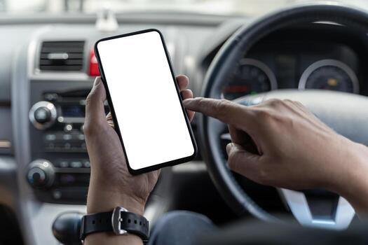 Mockup of man driver hand using blank white screen mobile smart phone inside a car, searching location via gps navigator application, close up photo
