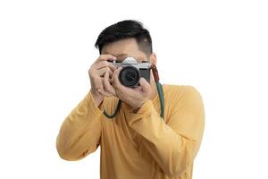Handsome young man holding DSLR camera on white. Professional male photographer with digital camera shooting in white isolated photo studio.