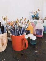 Creative workspace with painting tools on table photo