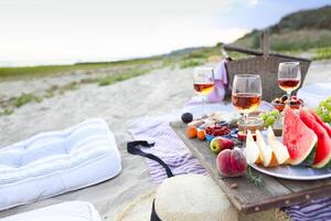 Picnic on the beach at sunset in the style of boho photo