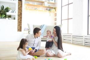 Happy family playing with colorful blocks at home photo